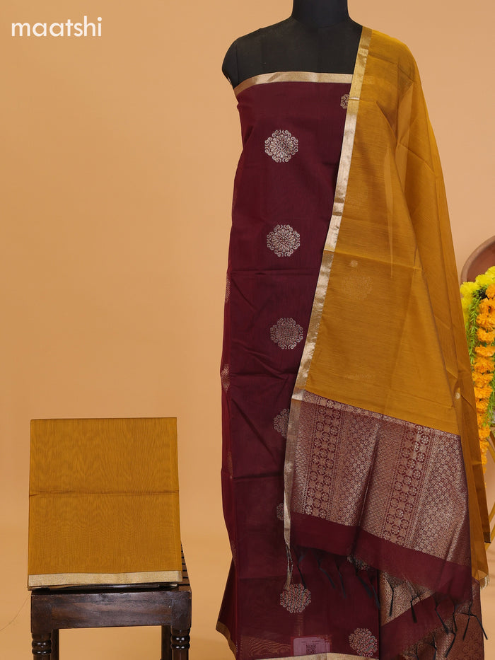 Dark Maroon and Mustard Yellow Semi Silk Cotton Dress Material With Zari Buttas and Bottom & Dupatta