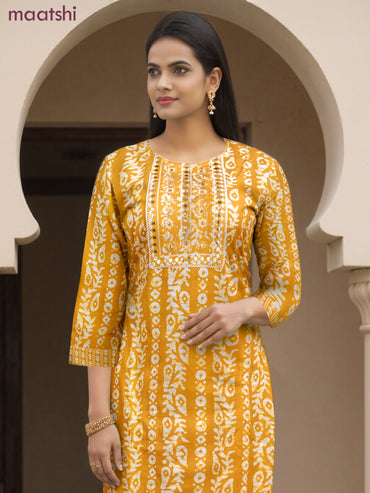 Cotton salwar suit mango yellow and off white with allover batik prints & embroidery lace work neck pattern and straight cut pant & dupatta