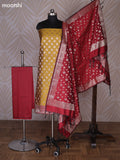 Mustrad Yellow and Maroon Banarasi Silk Dress Material With Allover Zari Buttas