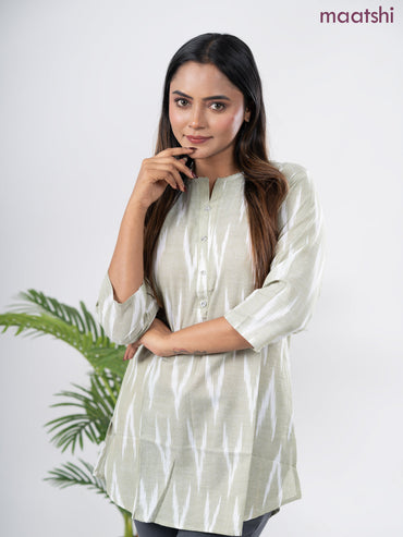 Cotton short kurti pastel green and off white with allover ikat weaves & simple neck pattern without pant