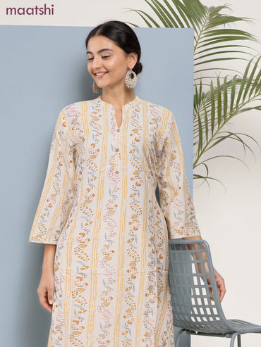 Cotton a-line kurti cream and pale yellow with allover floral prints & simple neck pattern without pant