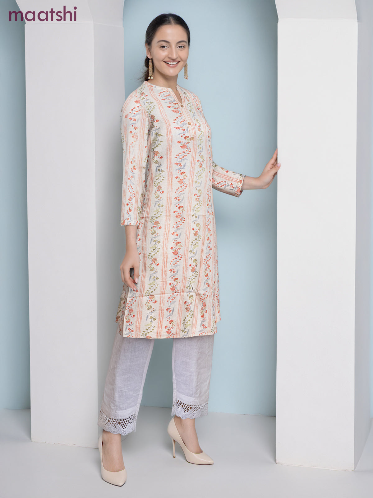 Cotton a-line kurti cream and pale orange with allover floral prints & simple neck pattern without pant