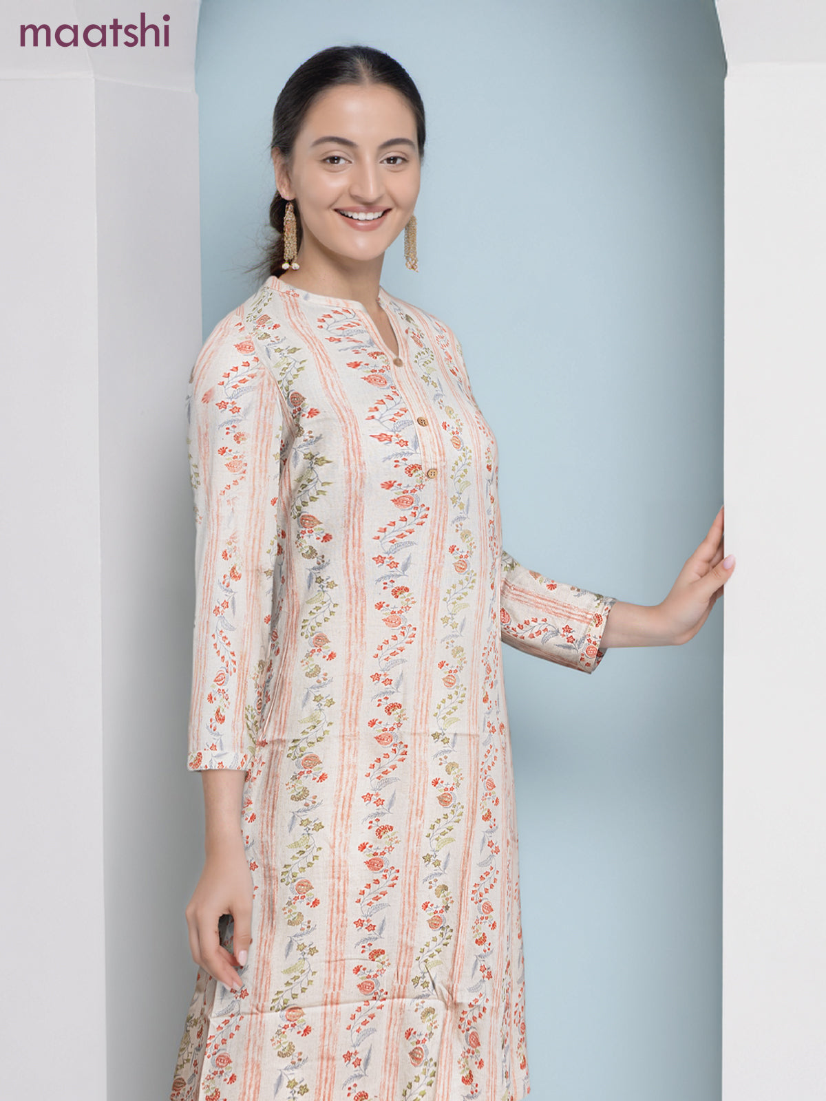 Cotton a-line kurti cream and pale orange with allover floral prints & simple neck pattern without pant