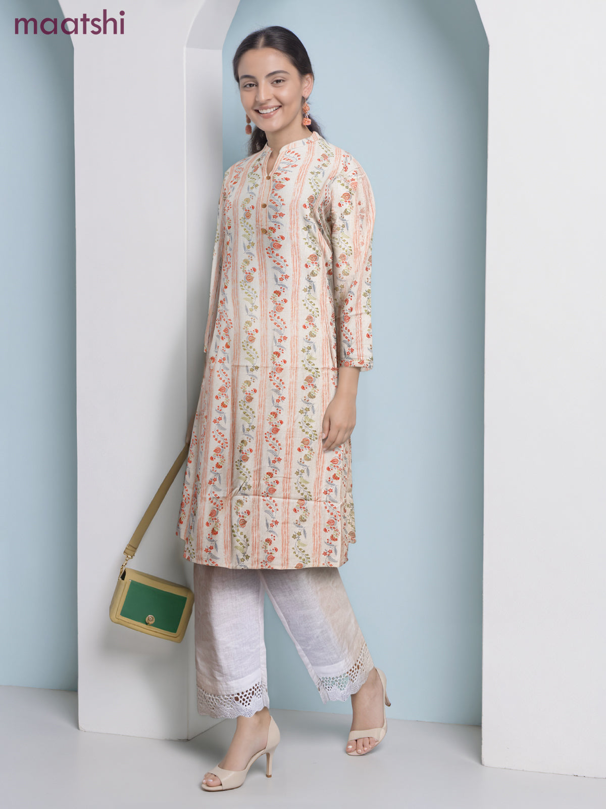 Cotton a-line kurti cream and pale orange with allover floral prints & simple neck pattern without pant