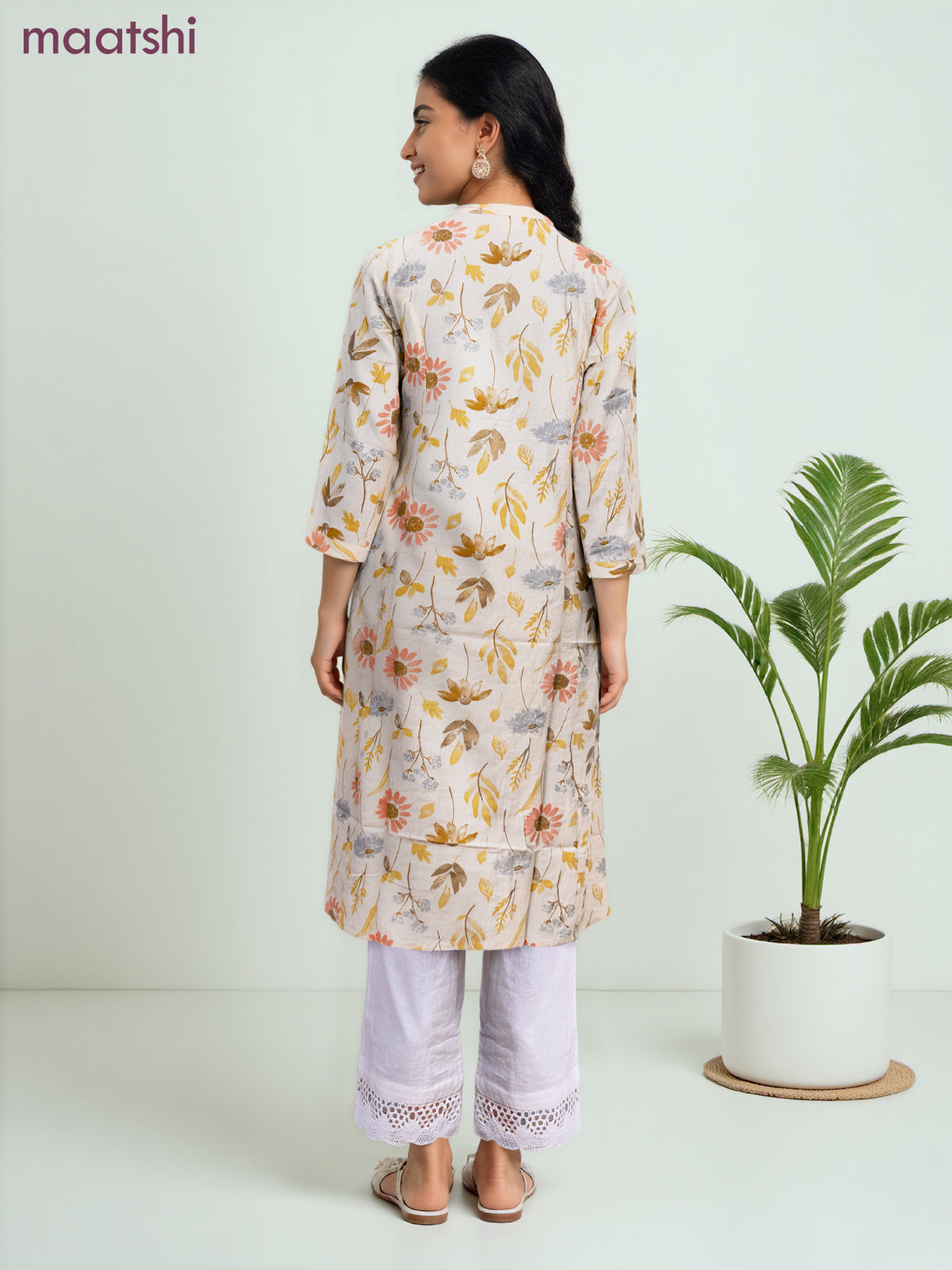 Cotton a-line kurti cream and yellow shade with allover floral prints & simple neck pattern without pant