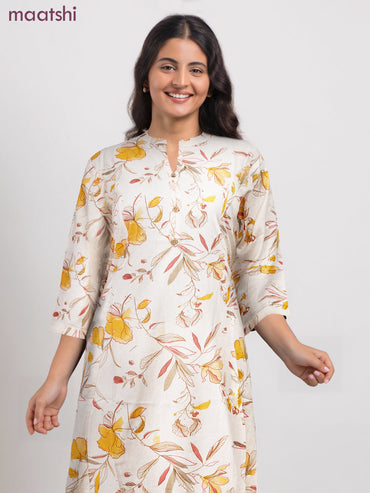 Cotton a-line kurti cream and yellow shade with allover floral prints & simple neck pattern without pant