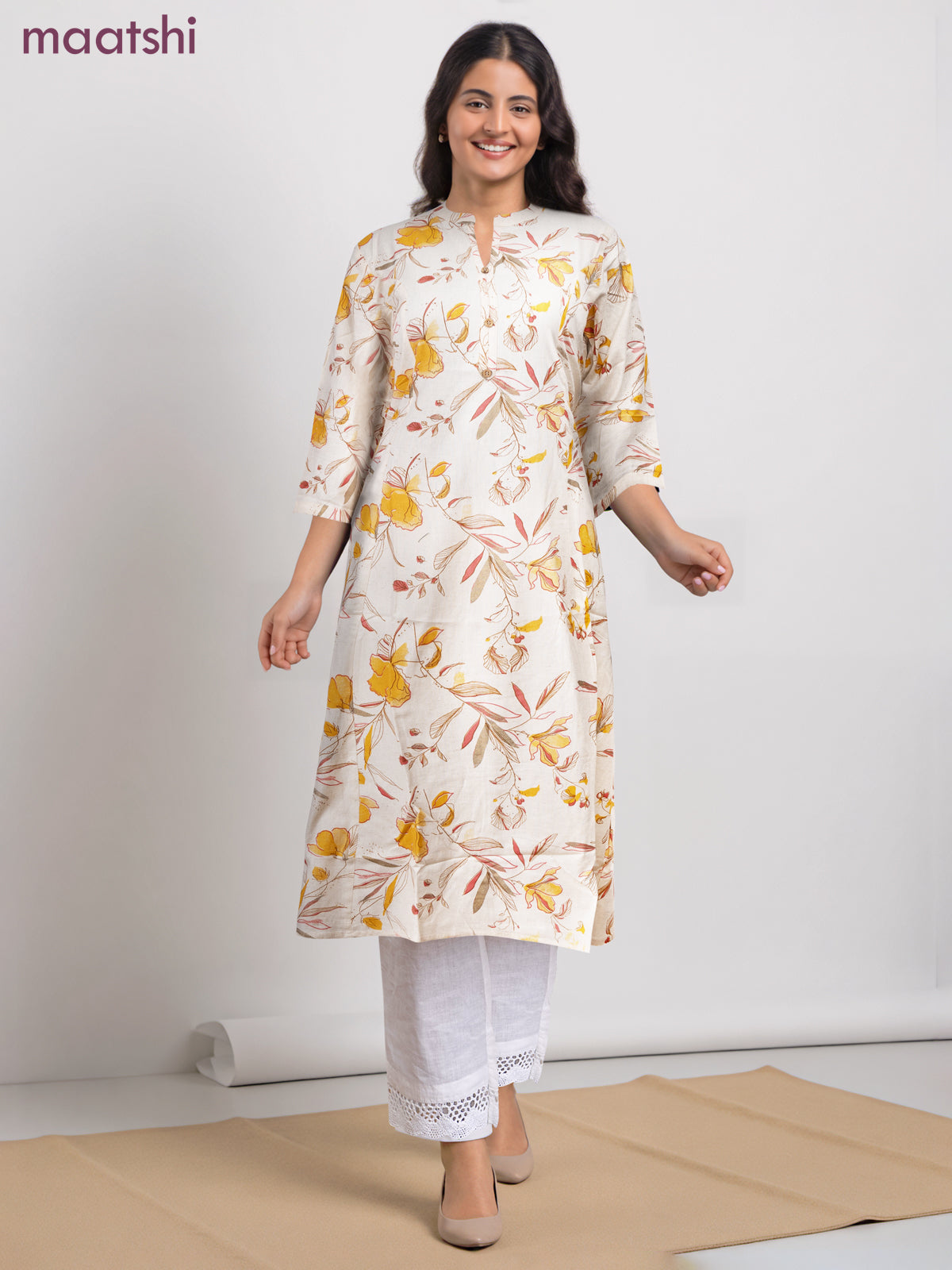 Cotton a-line kurti cream and yellow shade with allover floral prints & simple neck pattern without pant