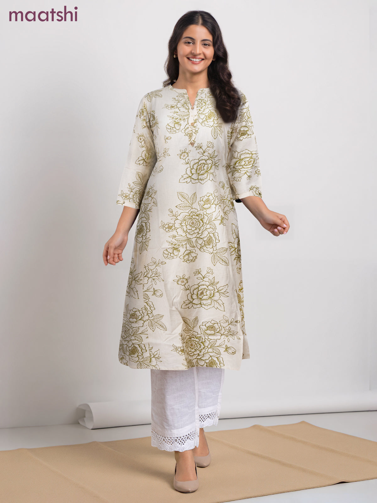 Cotton a-line kurti cream and green shade with allover floral prints & simple neck pattern without pant