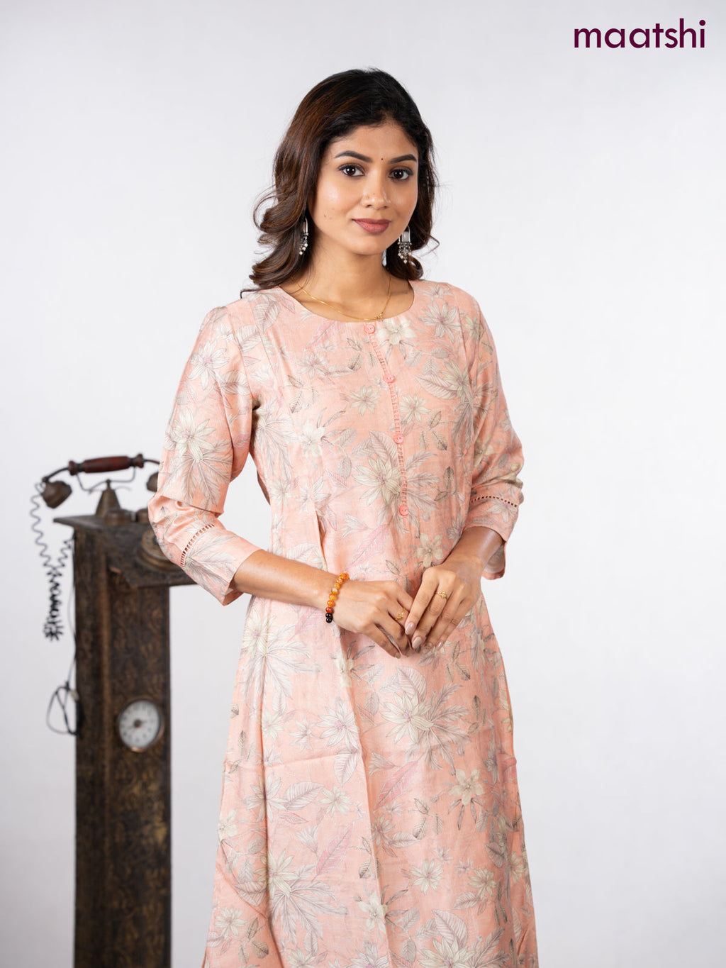 Rayon a-line kurti peach shade with allover floral prints & simple neck pattern without pant