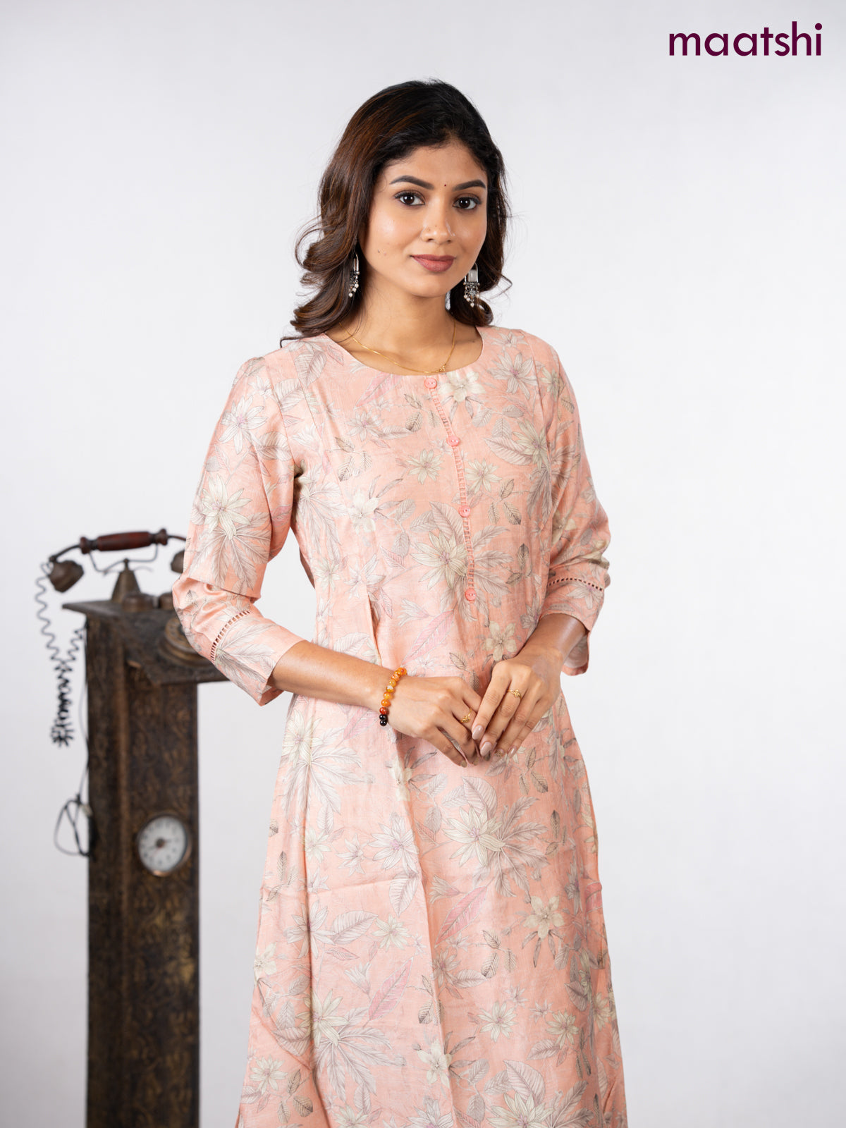 Rayon a-line kurti peach shade with allover floral prints & simple neck pattern without pant