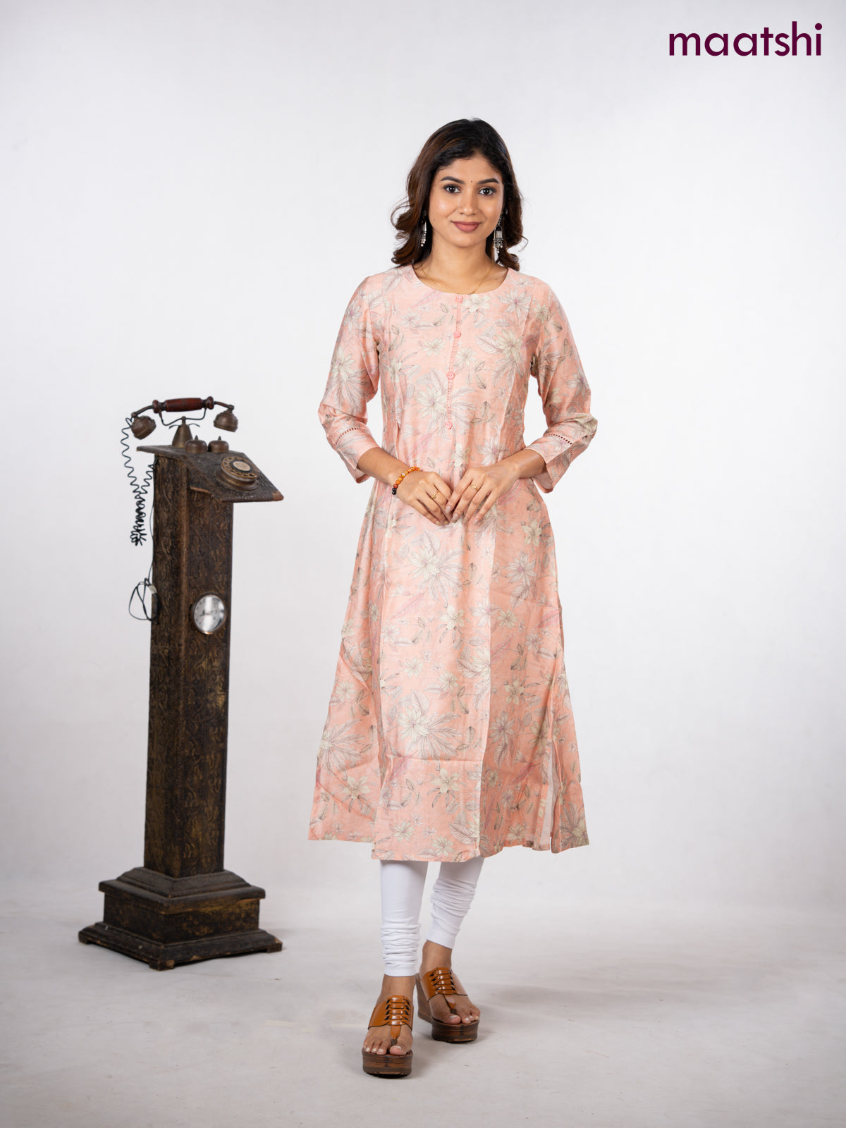Rayon a-line kurti peach shade with allover floral prints & simple neck pattern without pant