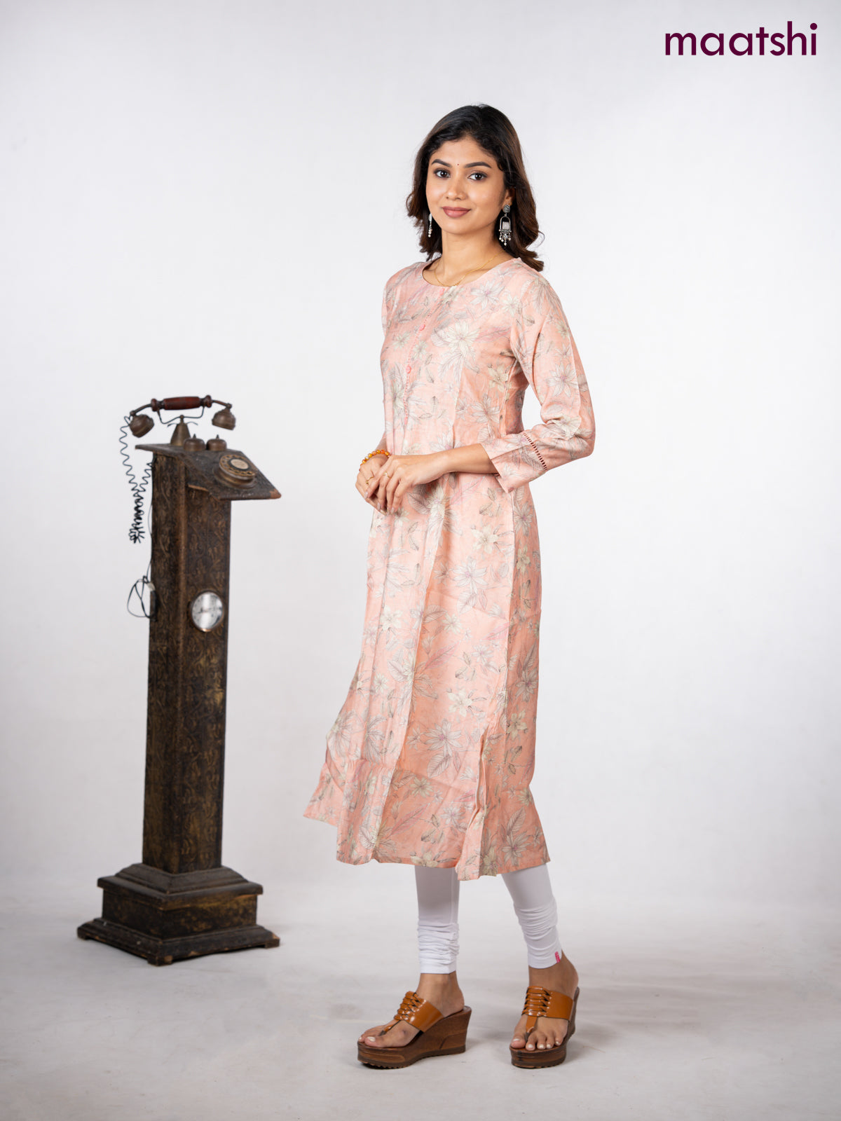 Rayon a-line kurti peach shade with allover floral prints & simple neck pattern without pant
