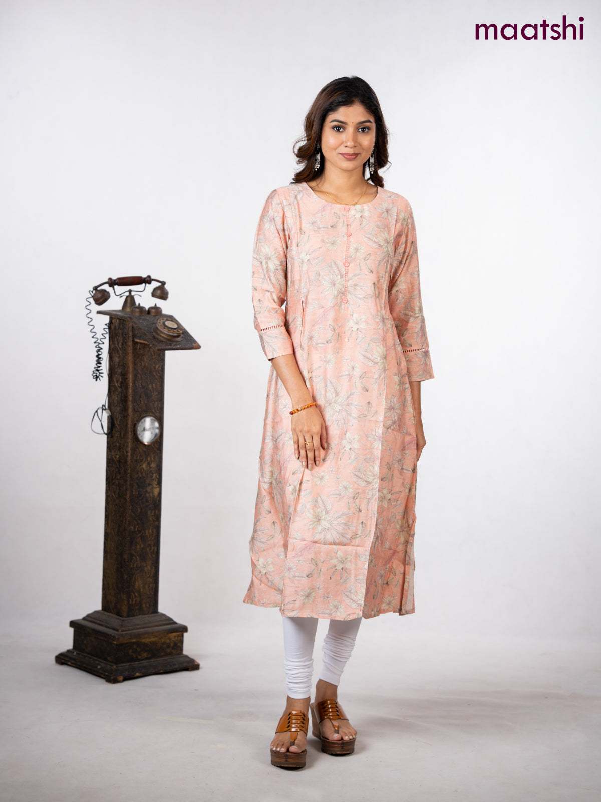 Rayon a-line kurti peach shade with allover floral prints & simple neck pattern without pant