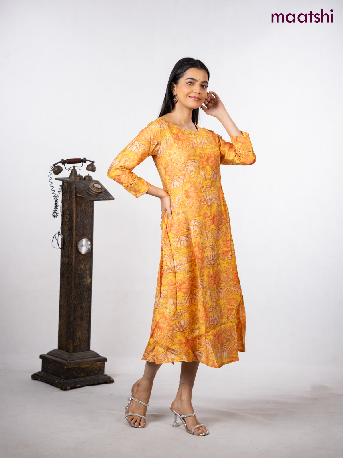 Rayon a-line kurti yellow with allover floral prints & simple neck pattern without pant