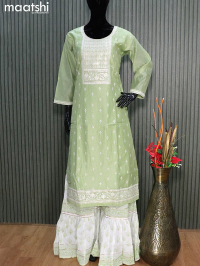 Raw silk readymade party wear salwar suits pastel green shade and off white with embroidery buttas & sequin work neck pattern and sharara pant & chiffon dupatta