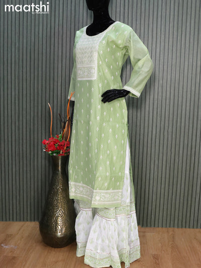 Raw silk readymade party wear salwar suits pastel green shade and off white with embroidery buttas & sequin work neck pattern and sharara pant & chiffon dupatta