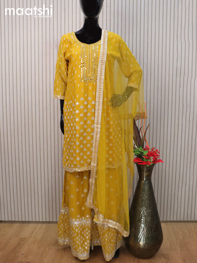Silk georgette readymade salwar suit mustard yellow with allover embroidery & mirror work neck pattern and sharara pant & netted dupatta sleeve attached