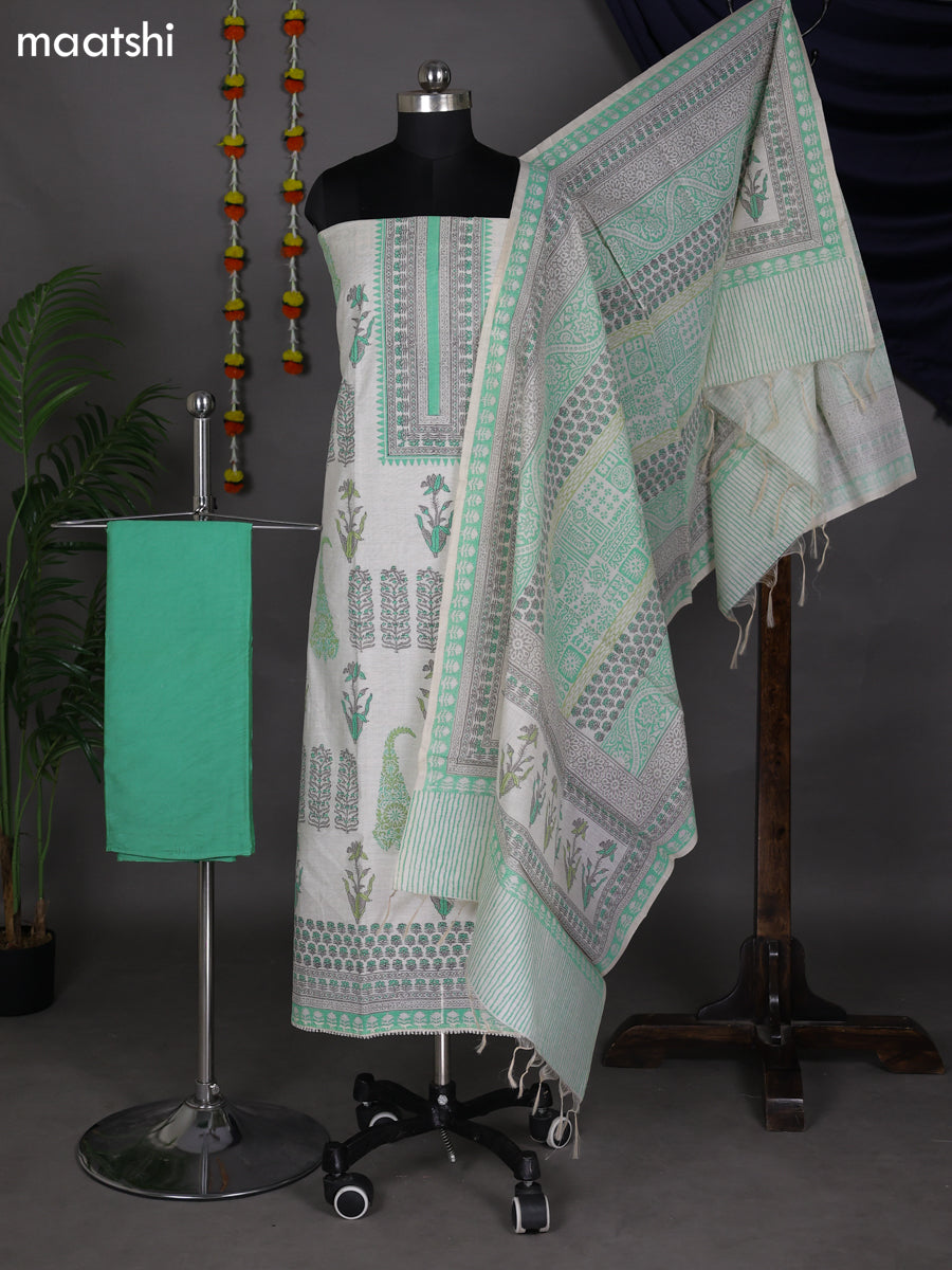 Off White and Teal Green Chanderi Dress Material With Allover Prints
