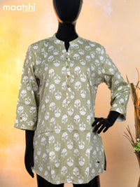 Rayon readymade short kurti pastel green and off white with allover floral butta prints & simple neck pattern without pant