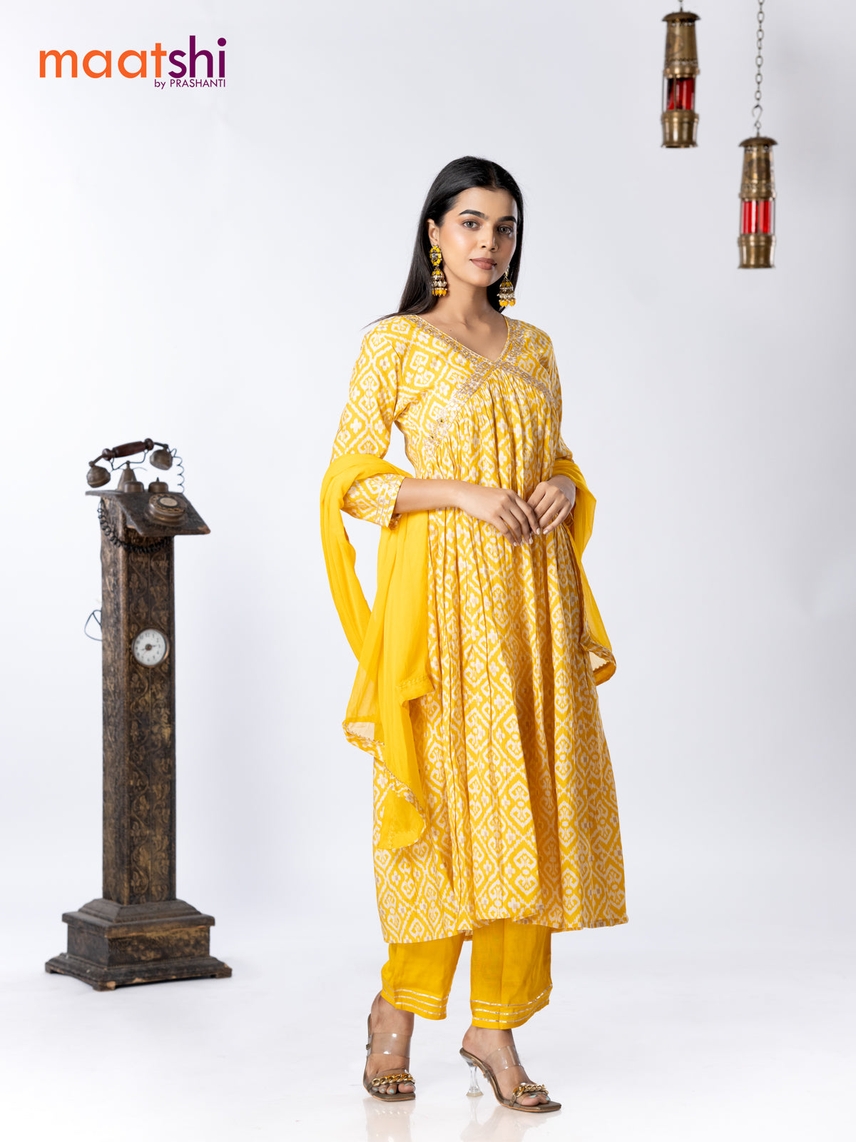 Muslin readymade alia cut salwar suit yellow and off white with allover ikat prints & embroidery mirror work neck pattern and straight cut pant & chiffon dupatta