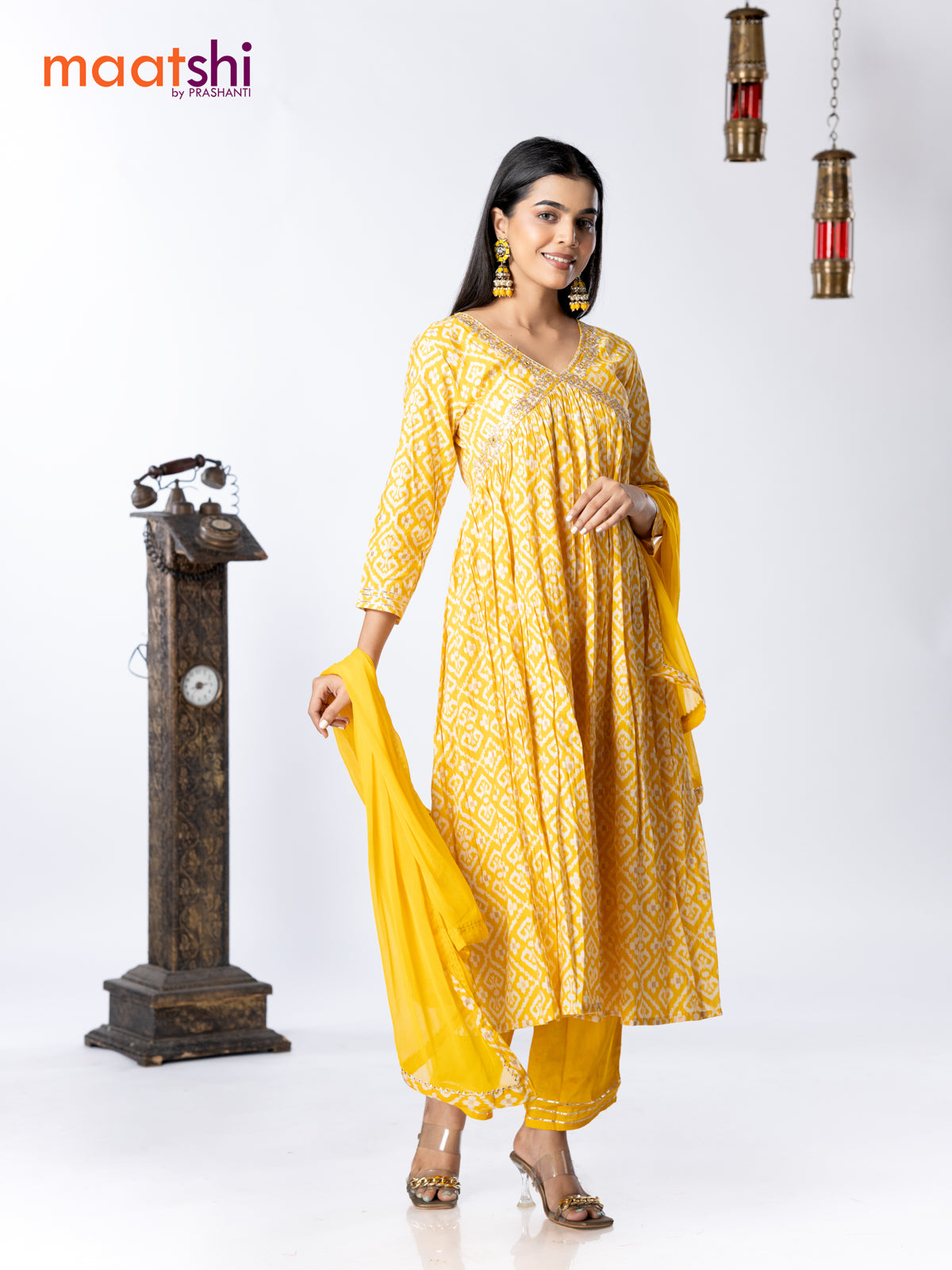 Muslin readymade alia cut salwar suit yellow and off white with allover ikat prints & embroidery mirror work neck pattern and straight cut pant & chiffon dupatta