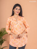 Cotton readymade short kurti pale orange with allover prints & simple neck pattern without pant