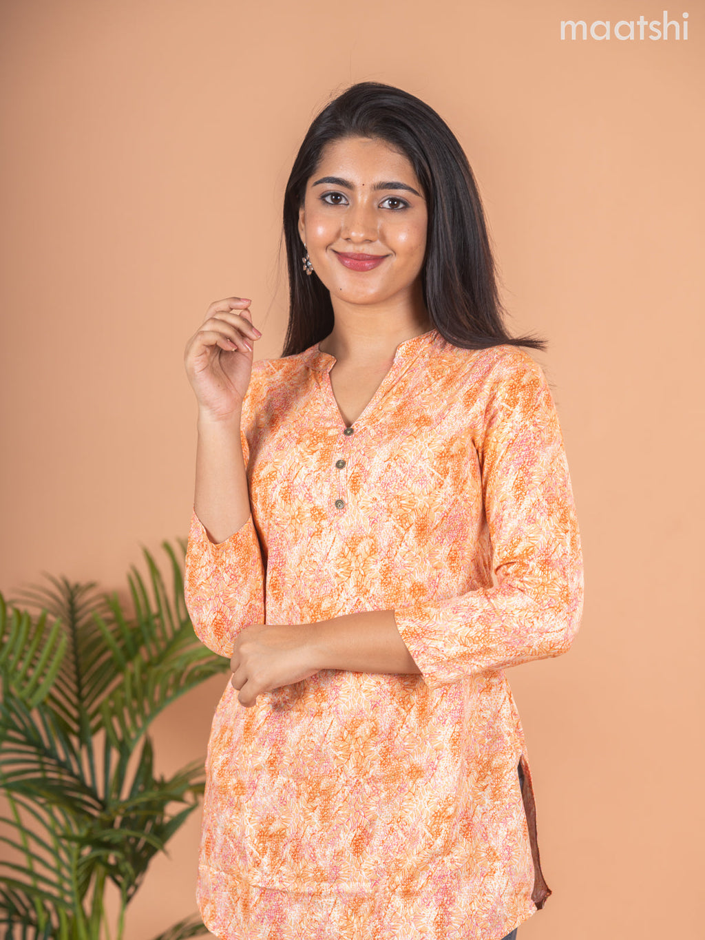 Cotton readymade short kurti pale orange with allover prints & simple neck pattern without pant