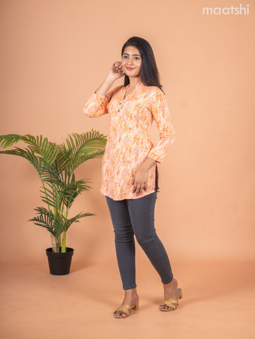 Cotton readymade short kurti pale orange with allover prints & simple neck pattern without pant