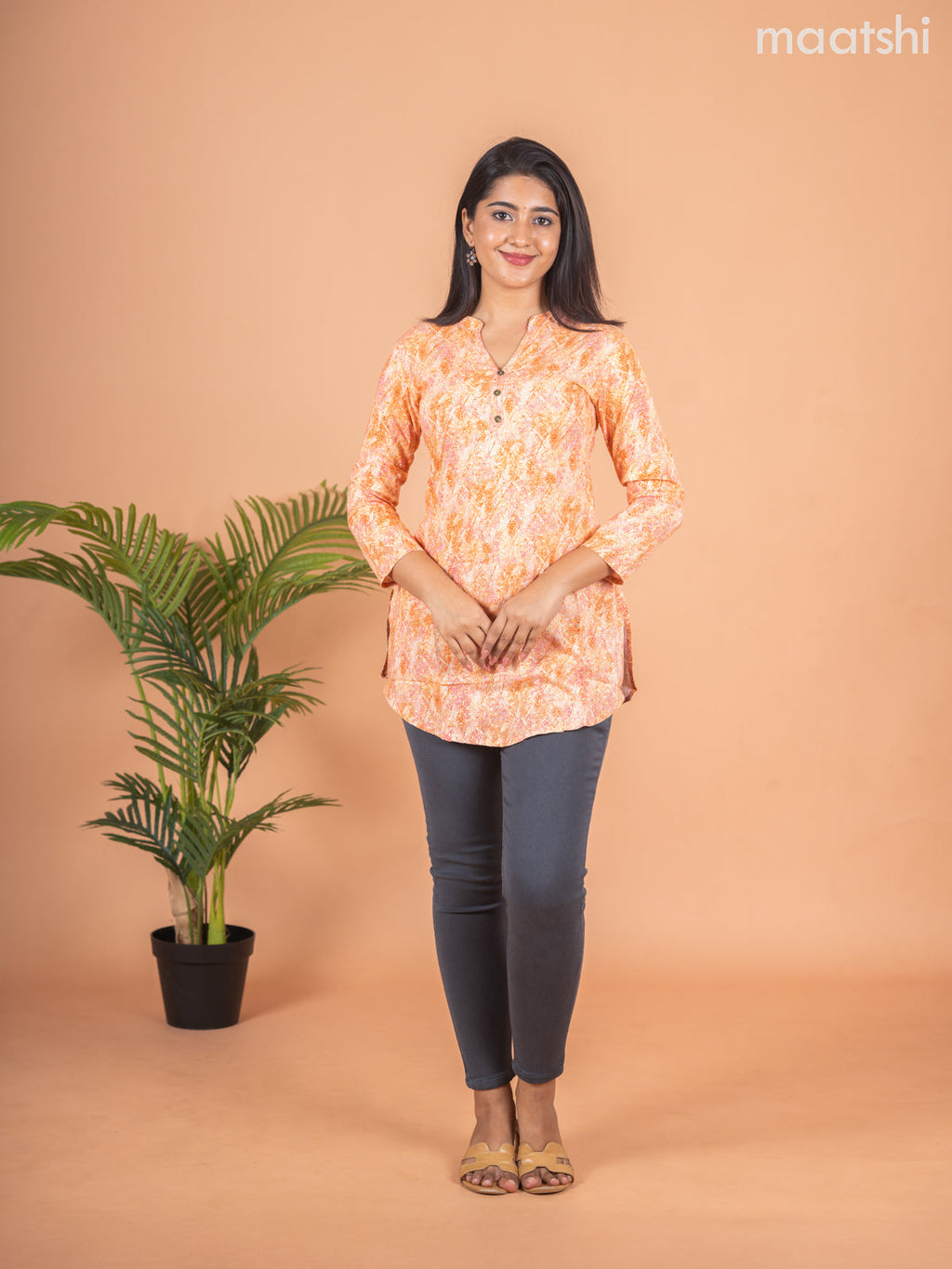 Cotton readymade short kurti pale orange with allover prints & simple neck pattern without pant