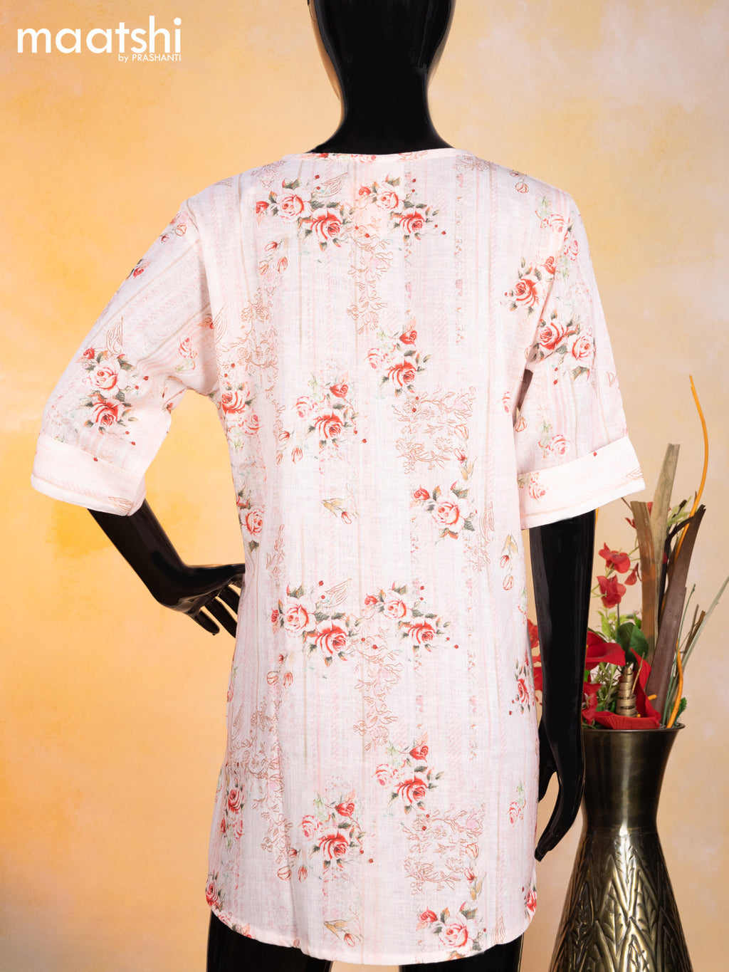Cotton readymade short kurti mild peach with allover floral prints & simple neck pattern without pant