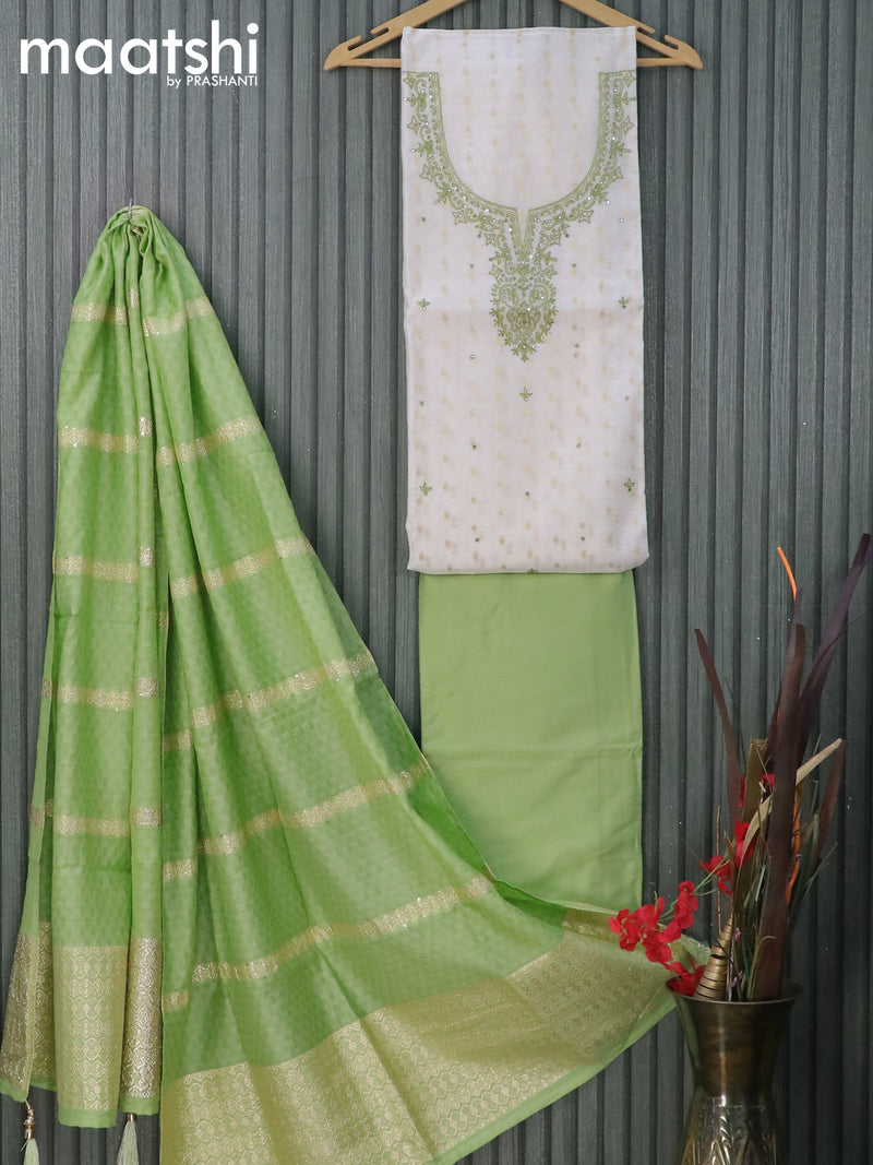 Raw silk dress material off white and light green with zari woven buttas & embroidery patch work neck pattern and pant & embroidery dupatta