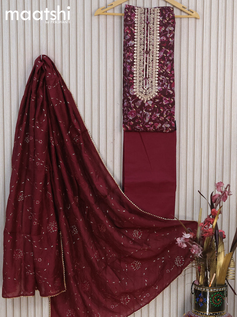 Modal dress material wine shade  with allover golden prints & embroidery work neck pattern and bottom & sequin work dupatta
