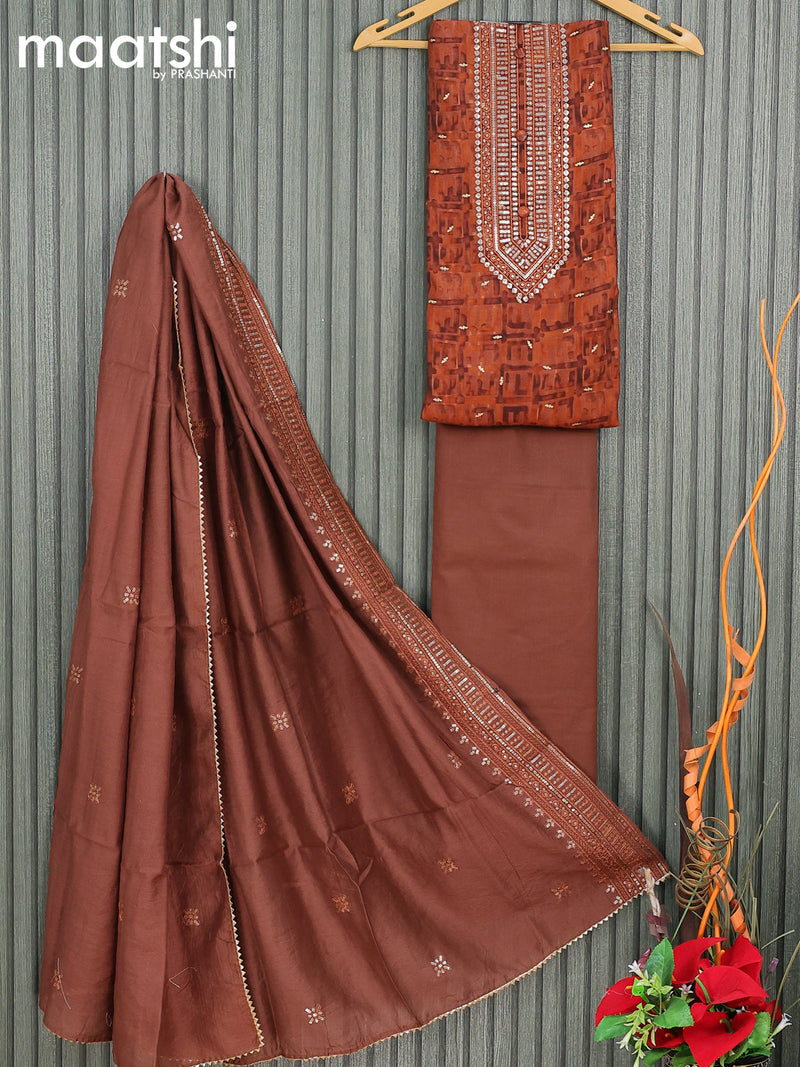 Modal dress material rust shade  with allover prints & sequin work neck pattern and bottom & sequin work dupatta