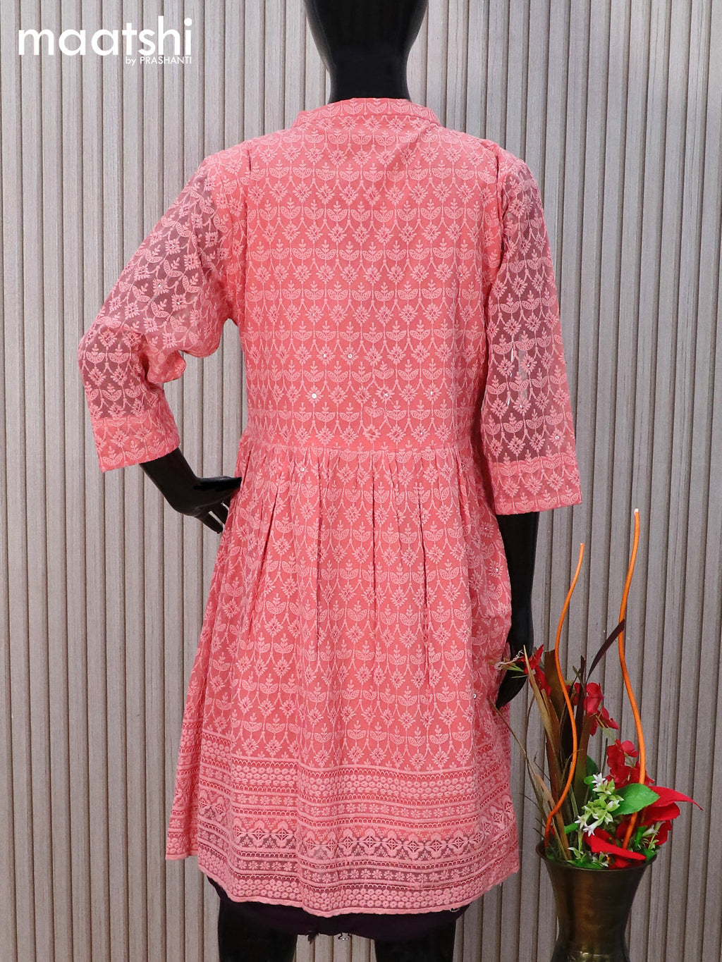 Semi georgette readymade tunic top peach shade with allover chikankari work & simple neck pattern without pant