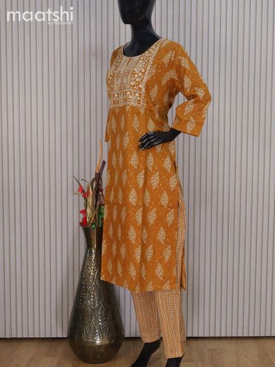 Rayon readymade salwar suit dark mustard with allover butta prints & embroidery sequin work neck pattern and straight cut pant