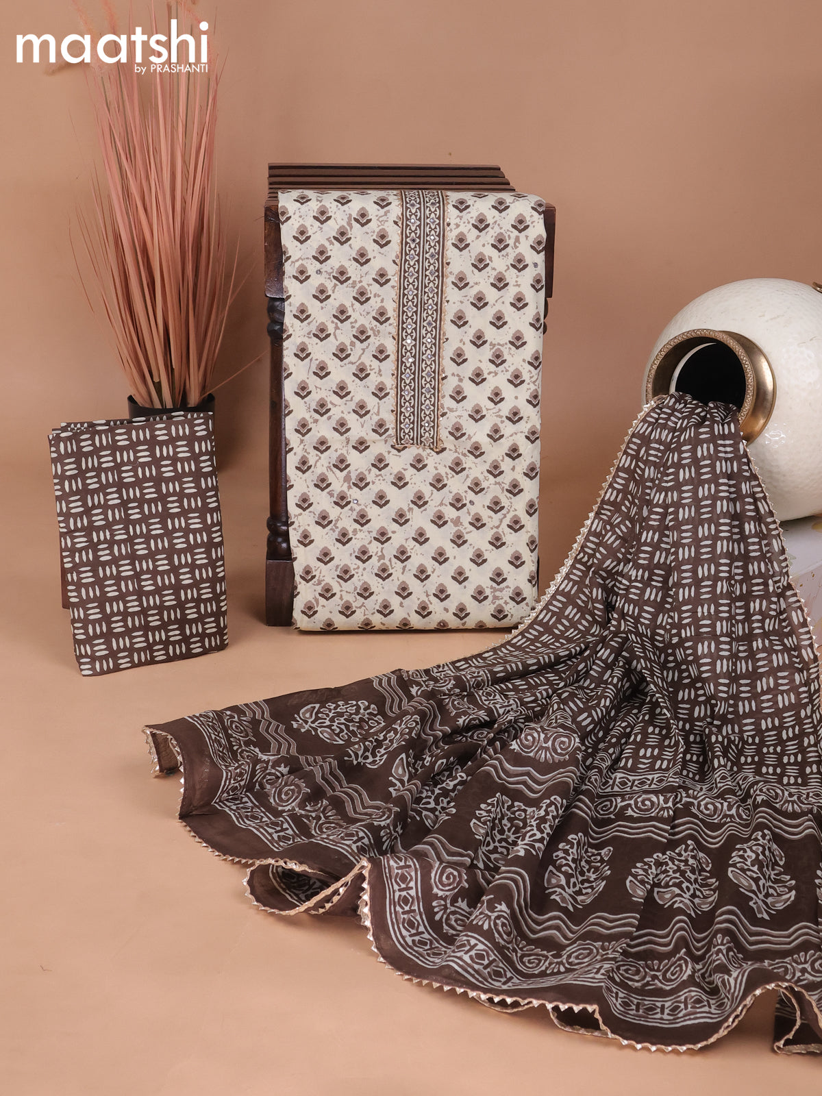 Cotton dress material cream and brown with allover ikat prints & patch work neck pattern and bottom & gottapatti lace work dupatta