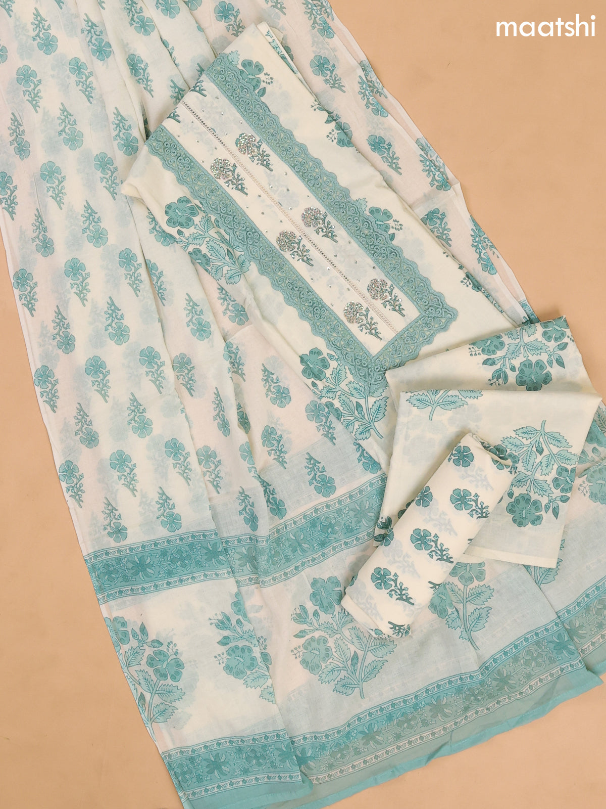 Off White and Teal Green Cotton Dress Materials With Floral Buttas and Lace Work Pattern