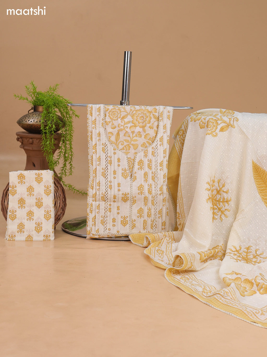 Off White and Mustard Cotton Dress Material With Allover Floral Prints and Lace Work Neck Pattern and Bottom & Dupatta