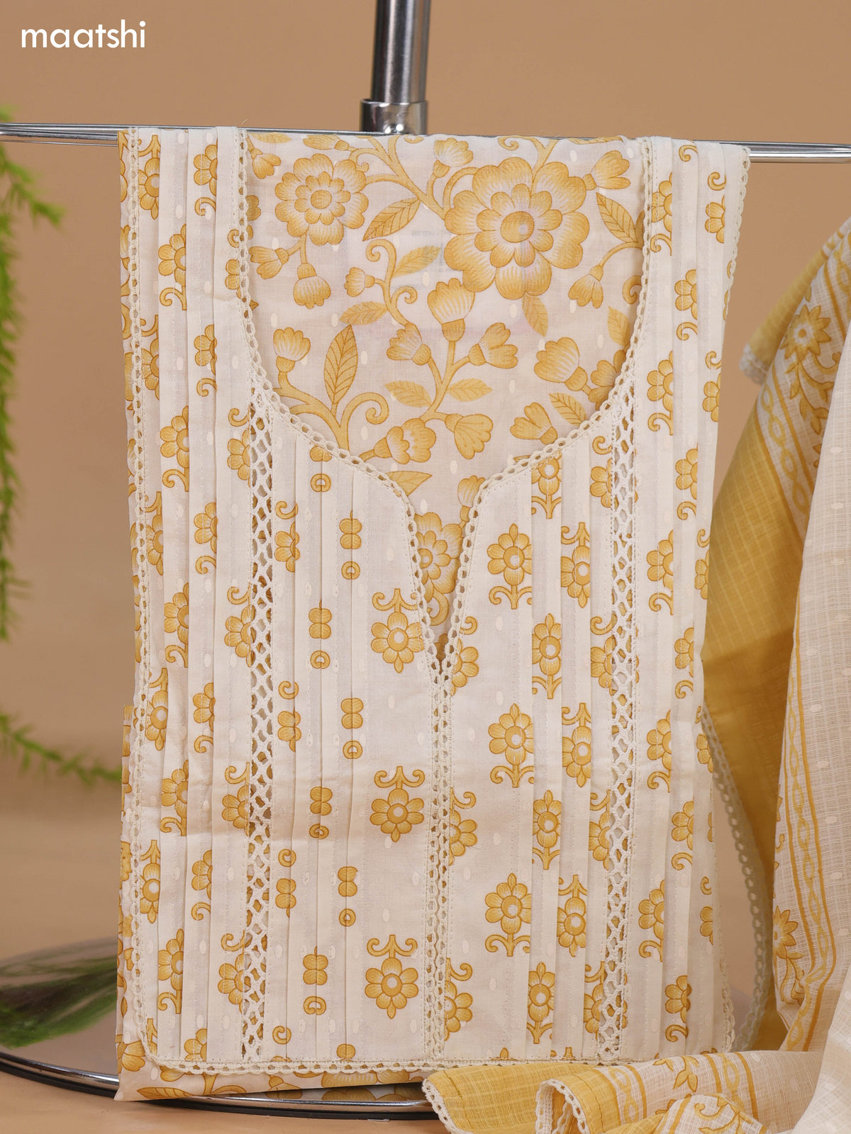 Off White and Mustard Cotton Dress Material With Allover Floral Prints and Lace Work Neck Pattern and Bottom & Dupatta