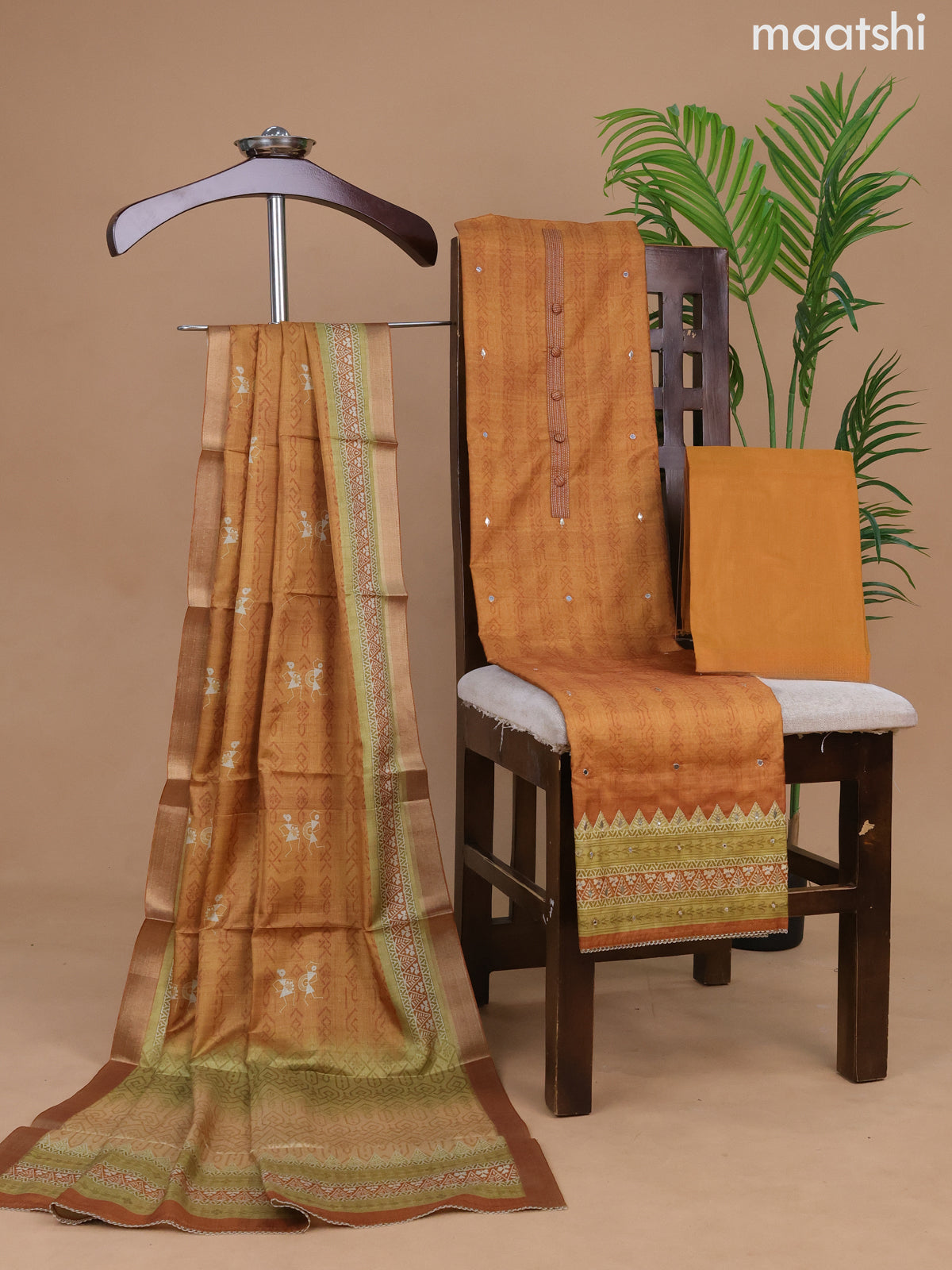 Semi tussar dress material mustard shade with allover prints & simple neck pattern and bottom & warli printed dupatta