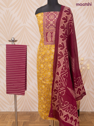 Cotton dress material mustard yellow and maroon with allover prints & patch work neck pattern and bottom & dupatta