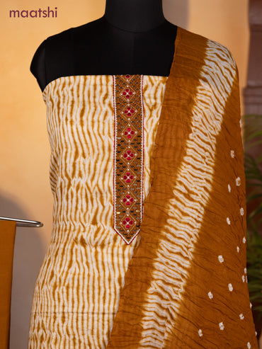 Bandhani dress materials off white and dark mustard with shibori prints & mirror embroidery work neck pattern and bottom & dupatta