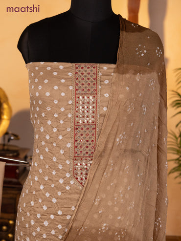 Bandhani dress materials beige with bandhani prints & zardosi mirror work neck pattern and bottom & chiffon dupatta