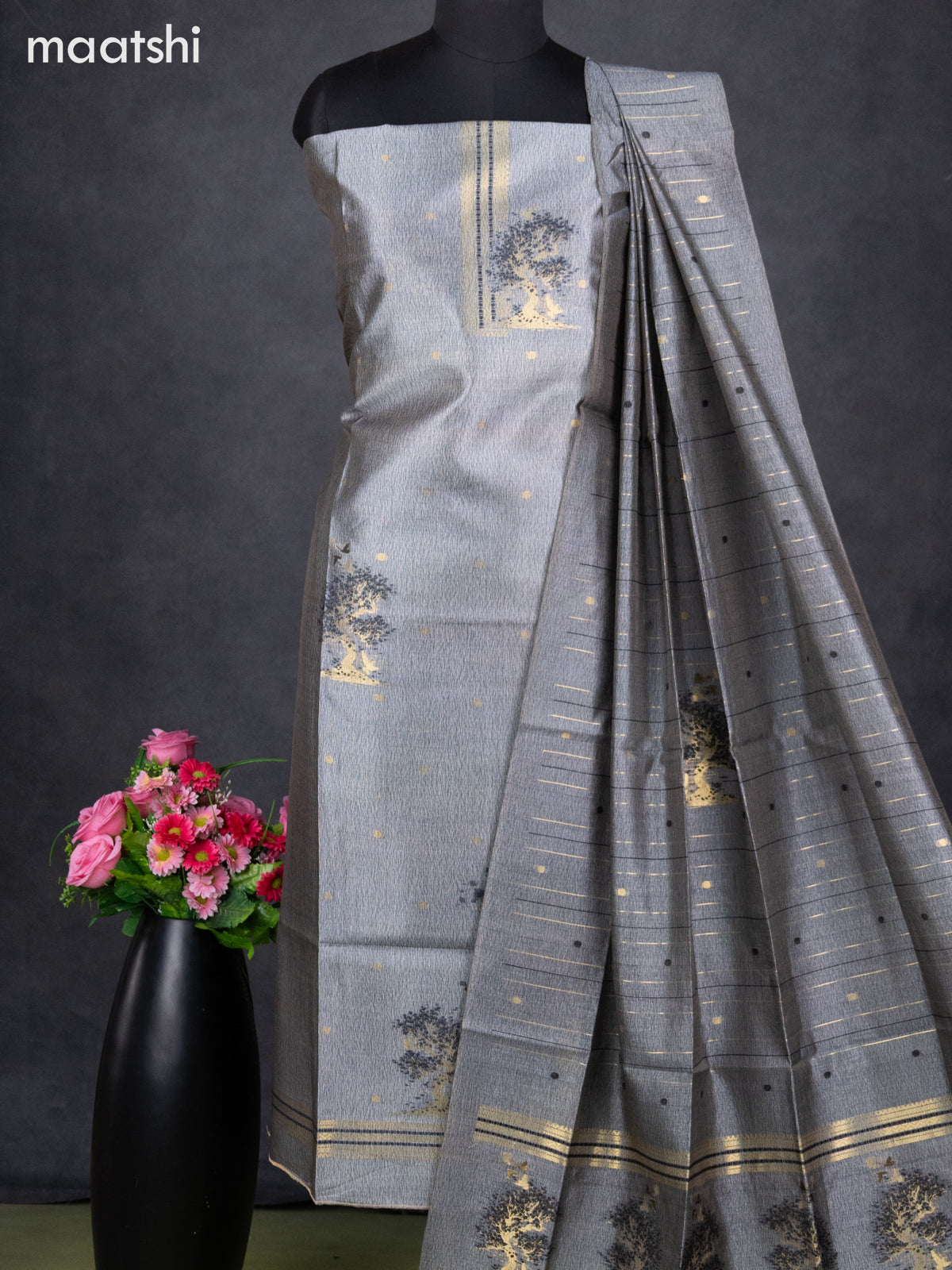 Semi tussar dress material grey with zari woven buttas & simple neck pattern and bottom & dupatta Semi tussar dress material grey with zari woven buttas & simple neck pattern and bottom & dupatta