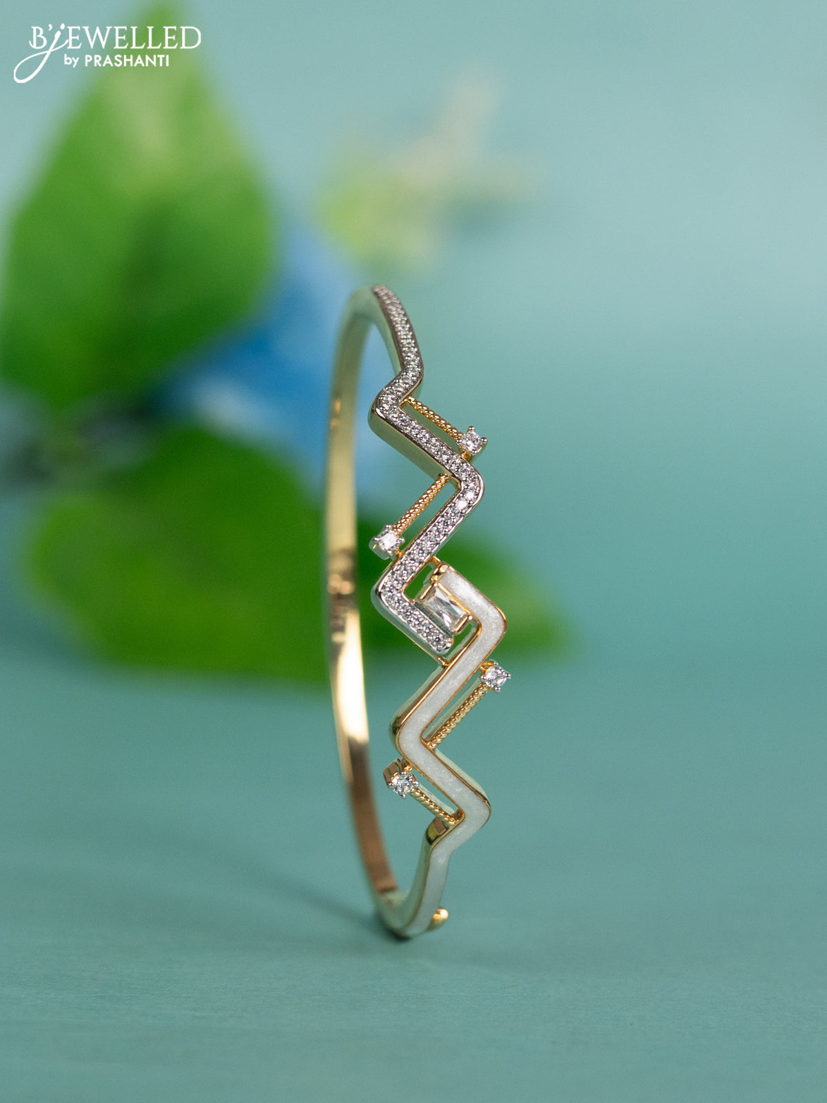 Zircon bracelet with white enamel and cz stones in gold finish