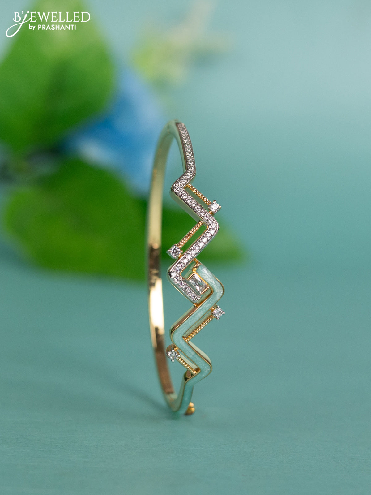 Zircon bracelet with ice blue enamal and cz stones in gold finish