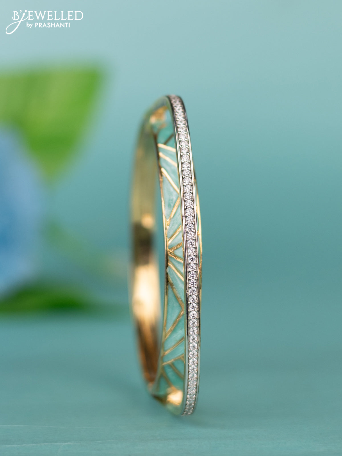 Zircon bracelet with ice blue enamal and cz stones in gold finish