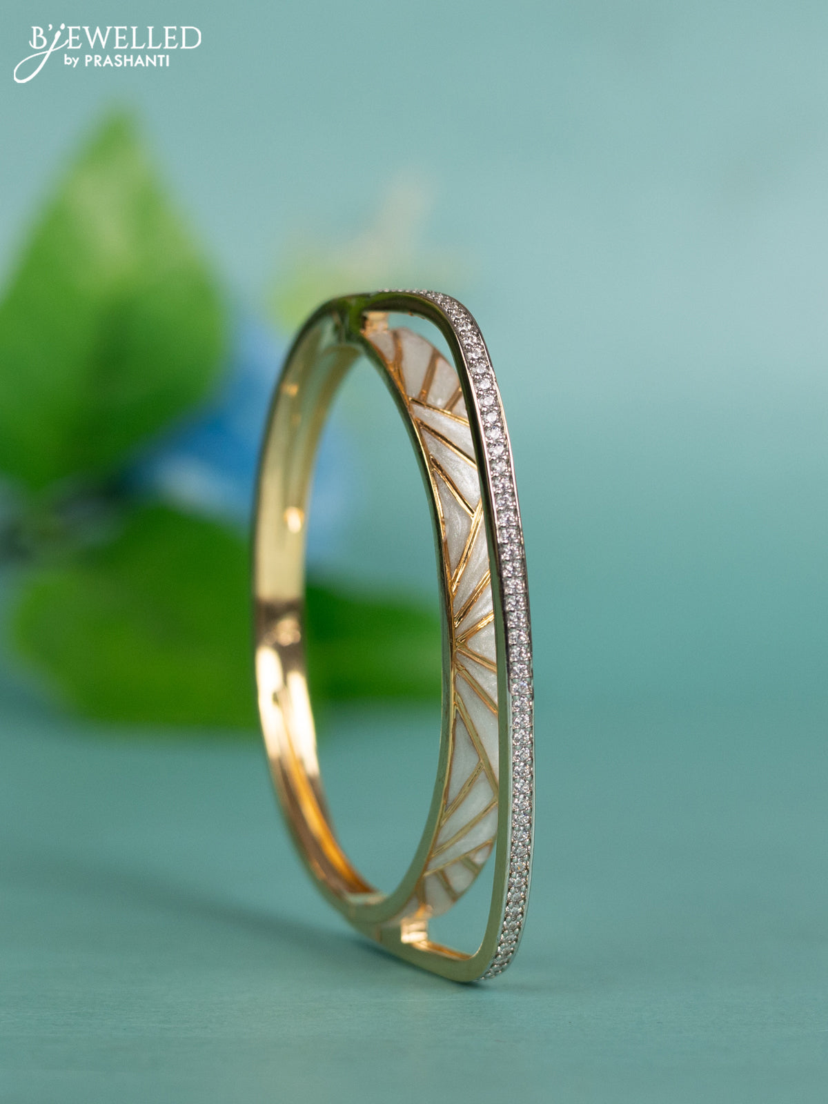 Zircon bracelet with white enamel and cz stones in gold finish