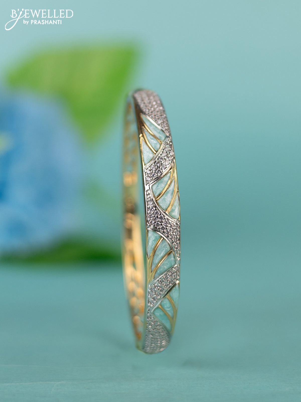 Zircon bracelet with ice blue enamal and cz stones in gold finish