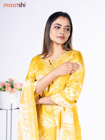 Crepe silk salwar suit mustard yellow with placement prints & beaded work neck pattern and straight cut pant & dupatta